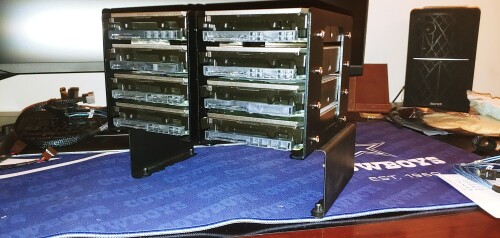 This is the crux of this build right here.  Eight 10TB HGST HE10 SAS Drives.  Ebay HDD Brackets, and a custom pedestal to mount them over the PSU.